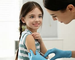 Nurse giving a child a vaccination